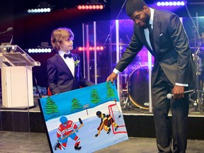 MAGIC MOMENT Gabriel Bellefleur patient and winner of the TD Nicolas W Matossian Junior Community Award of Excellence proudly displays his original artwork to PK Subban at the 2015 ball for the Children's.