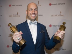 Martin Matte holds up his trophies for best television comedy show of the year and personality of the year at the Gala Olivier awards ceremony in Montreal, Sunday, May 10, 2015.