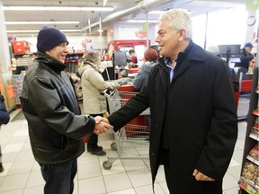 PA grocery store Taso Erimos (right) greets long-time customer Tommy Katsiroumbas at the main PA store on Parc Ave. in Montreal.