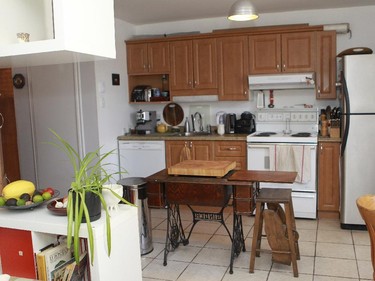 In the kitchen, there is a base of an old-fashioned treadle sewing machine which serves as an island.