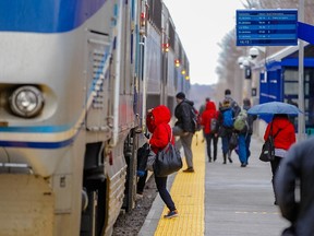 Passengers arrive to board the train heading to Saint-Jérôme at the Parc Station of the Saint-Jérôme line of the AMT in Montreal on Monday, April 27, 2015.