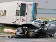A body lies wrapped in a blanket on the grass next to a city bus on its side after collision with a car on 55th ave. in the Lachine Borough, west of Montreal, Tuesday August 14, 2012.  Two people were killed in the accident. Stacey Snider, whose mother was killed in the crash, was later charged with impaired driving.