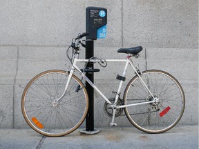 A bicycle is locked to a parking meter in Montreal in 2012.