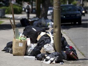 MONTREAL; QUE: JULY 3,  2011--  A  pile of garbage on Georges Vanier Boulevard near Lionel Groulx in Montreal, Tuesday July 3, 2011.  Residents say that the switch from twice weekly garbage pickup to once weekly has resulted in many piles of garbgag on the sidewalks and streets.   ( Phil Carpenter/ THE GAZETTE)