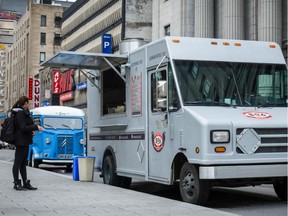 Food trucks So6, foreground, and Café Larue & Fils on Metcalfe St. in 2014.