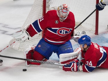 Montreal Canadiens defenceman Alexei Emelin tries to help Montreal Canadiens goalie Carey Price cover up a rebound during NHL semifinal action against the Tampa Bay Lightning at the Bell Centre in Montreal on Friday May 1, 2015.