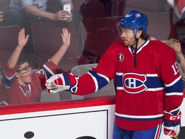 Montreal Canadiens right wing P.A. Parenteau acknowledges a young fan during the pre-game skate during NHL semifinal action against the Tampa Bay Lightning at the Bell Centre in Montreal on Friday May 1, 2015.