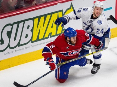 Montreal Canadiens right wing Brandon Prust gets knocked to the ice by Tampa Bay Lightning right wing Ryan Callahan during NHL semifinal action at the Bell Centre in Montreal on Friday May 1, 2015.
