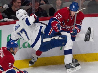 Montreal Canadiens right wing Dale Weise checks Tampa Bay Lightning defenceman Victor Hedman to the ice during NHL semifinal action at the Bell Centre in Montreal on Friday May 1, 2015. Montreal Canadiens centre Alex Galchenyuk, bottom right, follows the play.