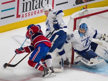 Montreal Canadiens right wing Brendan Gallagher, left, struggles with Tampa Bay Lightning defenceman Andrej Sustr as Tampa Bay Lightning goalie Ben Bishop gets his stick caught up in the pair during NHL semifinal action at the Bell Centre in Montreal on Friday May 1, 2015.