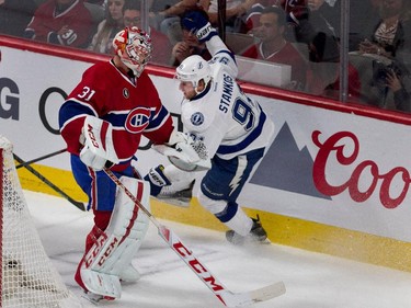 Tampa Bay Lightning centre Steven Stamkos hits the boards after getting nudged by Montreal Canadiens goalie Carey Price during NHL semifinal action at the Bell Centre in Montreal on Friday May 1, 2015.
