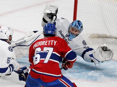 Tampa Bay Lightning goalie Ben Bishop dives across the goal crease to make a save against Montreal Canadiens left wing Max Pacioretty during overtime in NHL semifinal action at the Bell Centre in Montreal on Friday May 1, 2015.