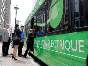 Passengers board a new fully electric bus in Montreal on Friday, May 15, 2015.