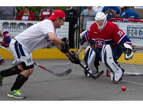 MONTREAL, QUE.: MAY 20, 2013--Former Montreal Canadiens goalie Richard Sevigny, right, prepares to stop  an unidentified player d from scoring during a ball hockey tournament organized by the Montreal Canadiens Children's Foundation at the YW/YMHA in Montreal on Monday May 20, 2013. (Allen McInnis / THE GAZETTE)  ORG XMIT: 46803