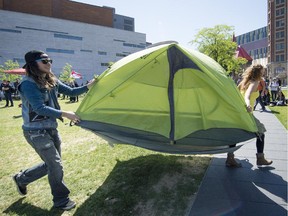Protesters with the Front d'action populaire en réamenagement urbain (FRAPRU) quickly set up tents at Place des Festivals to create their Camp pour le droit au logement in Montreal, on Thursday, May 21, 2015.