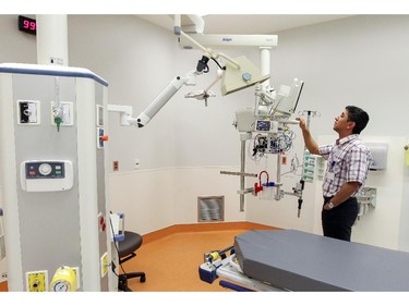Said Messaoui looks over equipment in a treatment room in the emergency room at new Montreal Children's Hospital at the Glen Site in Montreal Thursday May 21, 2015.  He works for Philips, the company that makes some of the equipment in the treatment room.