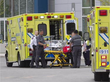 Ambulance and medical staff wheel an incubator from an ambulance at the MUHC Glen Campus, Sunday May 24, 2015, during the move the hospital from the old site on Tupper St.