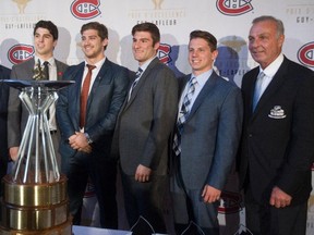 Former Canadiens great Guy Lafleur (right) poses with winners of the Guy Lafleur Awards of Excellence and Merit in Montreal on May 27, 2015. From the left are: Xavier Labonté of the Dragons du Collège Laflèche, Olivier Hinse of the Concordia Stingers, Jeremy Grégoire of the Baie-Comeau Drakkar, and Dominic Talbot-Tassi of the Moncton Wildcats.