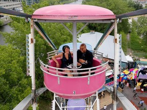 Katy Yam of Loto-Quebec, left, and Chris Denson of OMD / Ignition Factory take part in a Brain Date on a ferris wheel at C2MTL in Montreal on May 27, 2015.