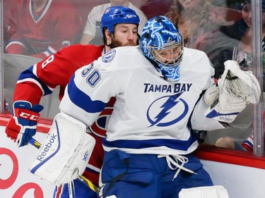Canadiens right wing Brandon Prust, left, collides with Tampa Bay Lightning goalie Ben Bishop, right, during the second period of game two of their NHL eastern conference semi-final hockey series at the Bell Centre in Montreal on Sunday, May 3, 2015.