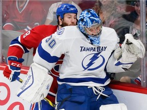 The Canadiens' Brandon Prust collides with Tampa Bay Lightning goalie Ben Bishop during the second period of Game 2 of their Eastern Conference semifinal series at the Bell Centre on May 3, 2015.  The Lightning won the game 6-2.