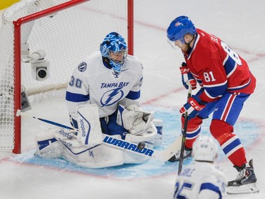 Tampa Bay Lightning goalie Ben Bishop, left, makes a save against Montreal Canadiens center Lars Eller, right, during the first period of game two of their NHL eastern conference semi-final hockey series at the Bell Centre in Montreal on Sunday, May 3, 2015.