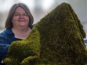 Suzanne Campeau with a sheet of moss at Bryophyta Technologies in Lanoraie.