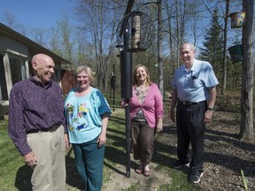 Carl Sandquist, Lyn Sandquist, Susan Bednarski and Gerry Foliot with bird feeders the Hudson Legion installed outside the windows of the Vaudreuil-Soulanges Palliative Care Residence in Hudson.