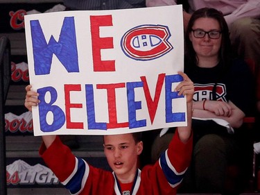 A young fan flashes a sign in support of the Montreal Canadiens during the pre game warmup skate before facing the Tampa Bay Lightning during NHL Eastern Conference semifinal action in Montreal on Saturday May 9, 2015.