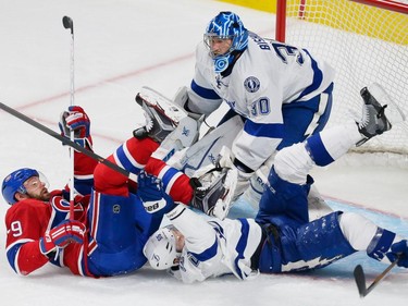 MONTREAL, QUE.: MAY 9, 2015 -- Montreal Canadiens defenceman Andrei Markov, left, an Tampa Bay Lightning defenceman Braydon Coburn, right, fall in front of Tampa Bay Lightning goalie Ben Bishop, top, during the second period of game five of their NHL Eastern Conference semifinal series at the Bell Centre in Montreal on Saturday, May 9, 2015. (Dario Ayala / Montreal Gazette)