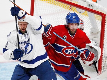 MONTREAL, QUE.: MAY 9, 2015--  Montreal Canadiens defenseman Tom Gilbert tries to clear Tampa Bay Lightning left wing Brenden Morrow from the goal crease as Montreal Canadiens goalie Carey Price peaks around them during NHL Eastern Conference semifinal action in Montreal on Saturday May 9, 2015.  (Allen McInnis / MONTREAL GAZETTE)