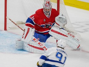 Montreal Canadiens goalie Carey Price, top, makes a save against Tampa Bay Lightning centre Steven Stamkos, bottom, during the first period of game five of their NHL Eastern Conference semifinal series at the Bell Centre in Montreal on Saturday, May 9, 2015.