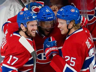 MONTREAL, QUE.: MAY 9, 2015 -- Montreal Canadiens right wing Devante Smith-Pelly, centre, is congratulated by teammates Torrey Mitchell, left, and Jacob De La Rose, right, after scoring a goal against Tampa Bay Lightning goalie Ben Bishop, not pictured, during the first period of game five of their NHL Eastern Conference semifinal series at the Bell Centre in Montreal on Saturday, May 9, 2015. (Dario Ayala / Montreal Gazette)