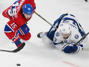 Montreal Canadiens right wing P.A. Parenteau, left, falls as he battles for the puck against Tampa Bay Lightning centre Cedric Paquette, right, during the second period of game five of their NHL Eastern Conference semifinal series at the Bell Centre in Montreal on Saturday, May 9, 2015.