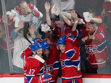 MONTREAL, QUE.: MAY 9, 2015 -- Montreal Canadiens right wing Devante Smith-Pelly, centre, is congratulated by teammates Torrey Mitchell, left, and Jacob De La Rose, right, after scoring a goal against Tampa Bay Lightning goalie Ben Bishop, not pictured, during the first period of game five of their NHL Eastern Conference semifinal series at the Bell Centre in Montreal on Saturday, May 9, 2015. (Dario Ayala / Montreal Gazette)