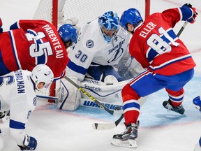 The Canadiens' Lars Eller and P.A. Parenteau look for a rebound against Tampa Bay Lightning goalie Ben Bishop during Game 5 of their NHL Eastern Conference semifinal series at the Bell Centre in Montreal on May 9, 2015.