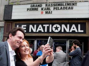 Pierre Karl Peladeau poses for a selfie with a supporter moments before a rally in Montreal on Saturday May 9, 2015.