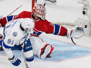 MONTREAL, QUE.: MAY 9, 2015 -- Tampa Bay Lightning center Steven Stamkos, left, scores on Montreal Canadiens goalie Carey Price, top, during the third period of game five of their NHL Eastern Conference semifinal series at the Bell Centre in Montreal on Saturday, May 9, 2015. (Dario Ayala / Montreal Gazette)