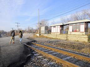 Commuters cross the tracks at the Île Perrot AMT commuter train station in 2016.