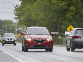 Motorists drive along Boulevard Cité des Jeunes between Montée Labossière and St. Louis in Saint Lazare west of Montreal, Sunday, September 21, 2014.