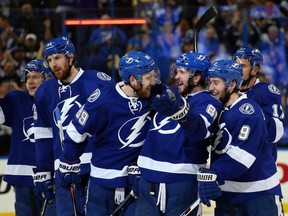 Nikita Kucherov (#86) of the Tampa Bay Lightning celebrates with his teammates after scoring the game-winning goal in overtime to defeat the New York Rangers 6-5 in Game Three of the Eastern Conference Finals during the 2015 NHL Stanley Cup Playoffs at Amalie Arena on May 20, 2015 in Tampa, Florida.