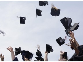 Newly minted local college graduates take part in the annual Toss Your Caps class photo Friday, May 8, 2015, on the steps of the Philadelphia Museum of Art in Philadelphia.