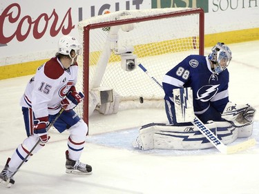 Montreal Canadiens right wing P.A. Parenteau, left, watches as a shot by defenseman Jeff Petry gets past Tampa Bay Lightning goalie Andrei Vasilevskiy,right, of Russia, during the second period of Game 4 of a second-round NHL Stanley Cup hockey playoff series in Tampa, Fla., Thursday, May 7, 2015.