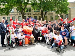 Participants in the fourth annual day-long Hockey de rue  ball-hockey tournament, including former Canadiens defenceman Patrice Brisebois (back row, arms raised), raised funds for the Montreal Canadiens Children's Foundation and the YM-YWHA.