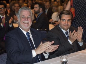 Quebec Premier Philippe Couillard, left, and Montreal Mayor Denis Coderre during the opening session of the Quebec Union of Municipalities annual convention in Montreal.