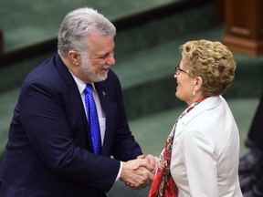 Ontario Premier Kathleen Wynne, right, thanks Quebec Premier Philippe Couillard for his speech in the Chamber at Queen's Park in Toronto May 11, 2015.