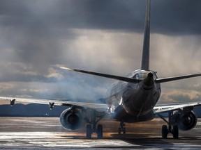 An airplane waits for takeoff on the tarmac.