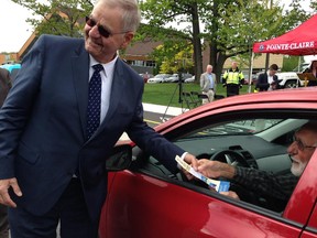 Pointe-Claire Mayor Morris Trudeau hands Jim Scott a 'ticket' for being a good driver and stopping at a stop sign.