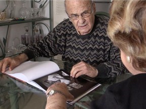 Simon Rappaport, who suffers from dementia, tries to remember faces in a family photo album with his wife and caregiver Myra Rappaport, 78. Myra is upset a lack of funding means the loss of a seniors' drop-in centre  her husband attended. Te move is expected to be disruptive, spoke Tuesday, May 12, 2015 in their Côte St. Luc, Montreal home.