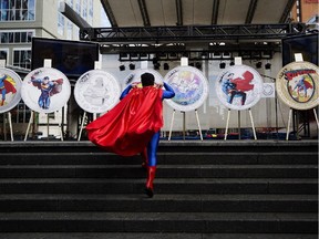 Superman fan Norman Antonio wears a costume as he attends the unveiling of the Royal Canadian Mint's Superman commemorative coins in Toronto on Monday, Sept. 9, 2013.